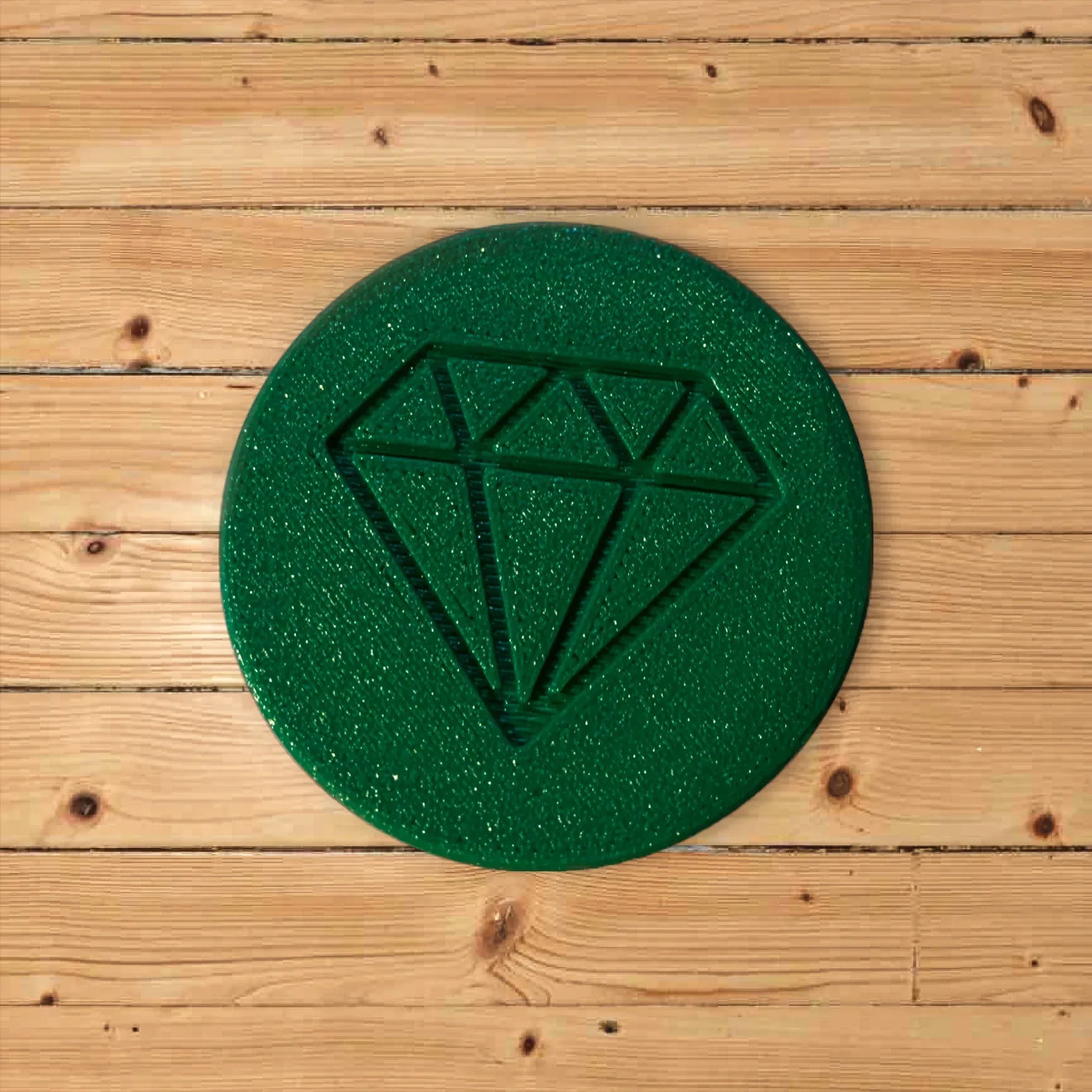 Grinder circulaire vert scintillant avec motif diamant en relief.